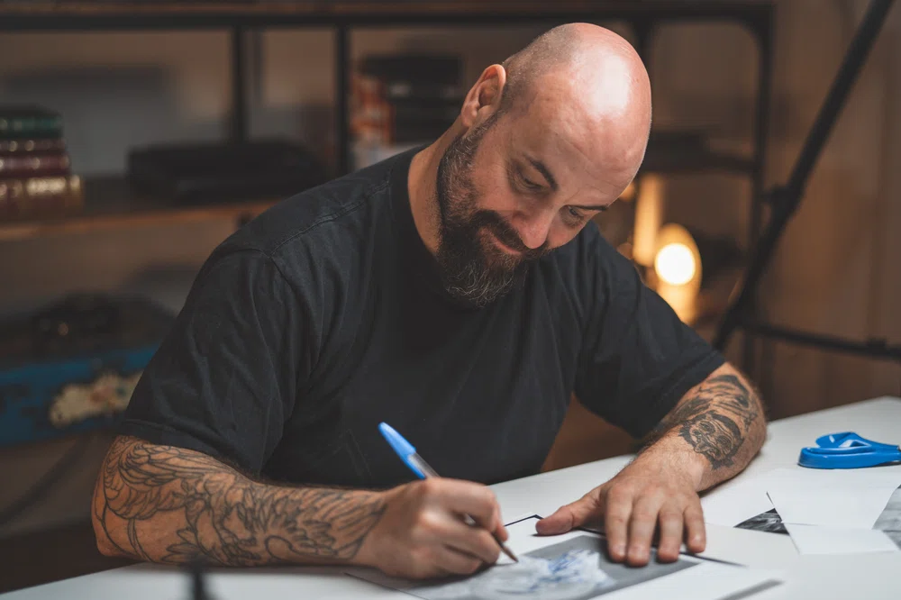 Blackwork tattoo artist, Enric Rebollo, making a drawing for his 10 Masters training.