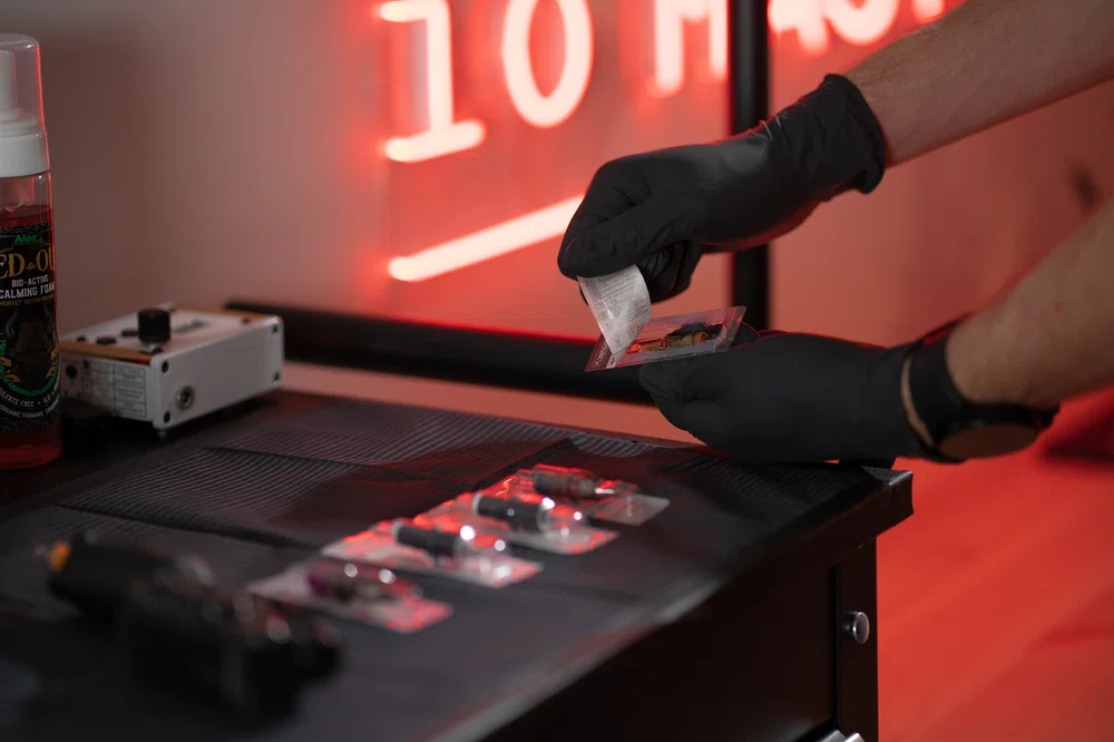 tattoo artist organizing his tools in his studio