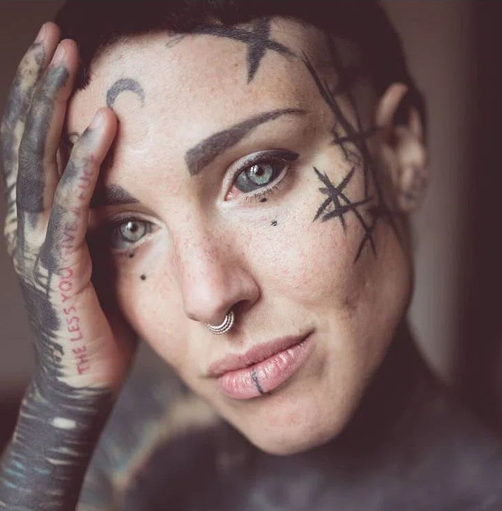 Woman showing palm with eye tattoo stock photo