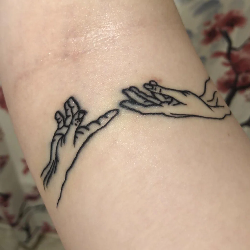 black hands tattoo inspired by Michelangelo painting